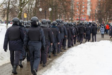 Public meeting in support of Navalny, police officers in black helmets wait for the command to arrest the protesters.