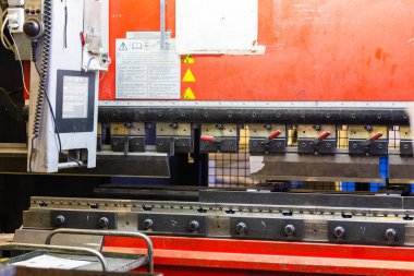 closeup view of industrial sheet bending press brake with tool