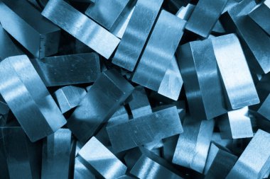 pile of rectangular steel workpieces after surface grinding