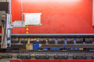 closeup view of industrial sheet bending press brake with tool