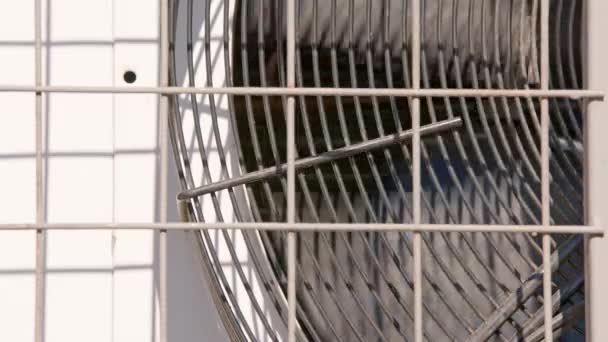Outdoor air conditioner condenser electrical fan spinning — Video