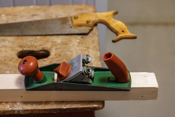 Planer, saw and wooden block on a stool — Fotografia de Stock