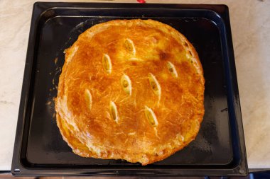 freshly baked domestic ossetian pie on a baking sheet
