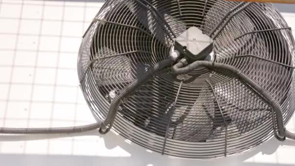 Outdoor air conditioner condenser fan decelerating and slowly stopping — Stockvideo