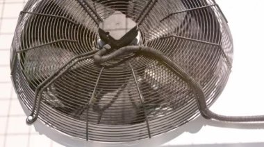 outdoor air conditioner condenser fan spinning, decelerating and accelerating