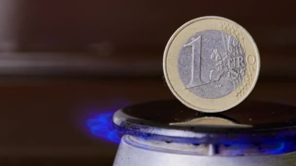 Gas stove burner with one euro coin standing vertically on top, burning gas with — Video