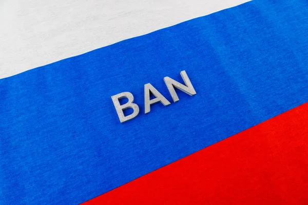 The word ban laid with silver metal letters over fabric Russian Federation flag — Foto Stock