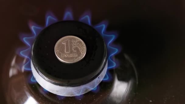 Gas stove burner with russian ruble on top burning natural gas with blue flame — Wideo stockowe