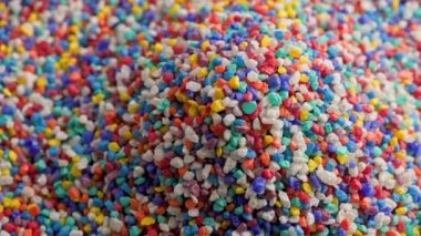 crushed colored stones heap slowly spinning, loopable closeup
