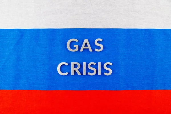 the words gas crisis laid with silver letters over flat russian flag surface