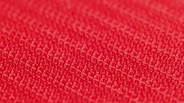 Close-up macro view of red velcro surface with micro hooks — Video