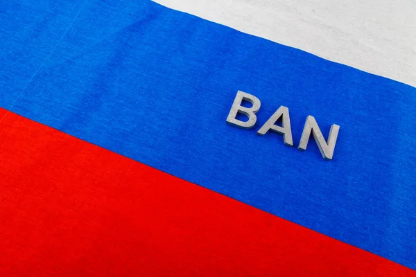 The word ban laid with silver metal letters over fabric Russian Federation flag — Foto Stock