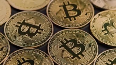 bitcoin coins on black background - closeup full-frame spinning background