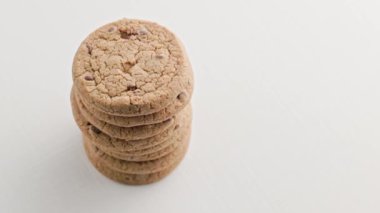 rotating vertical stack of round chip cake cookies with chocolate on white