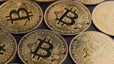bitcoin coins on black background - closeup full-frame spinning background