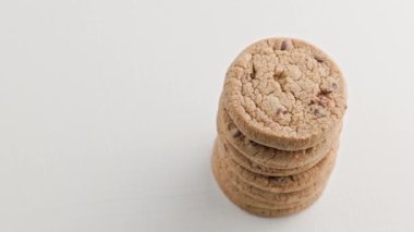 rotating vertical stack of round chip cake cookies with chocolate on white