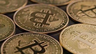 bitcoin coins on black background - closeup full-frame spinning background