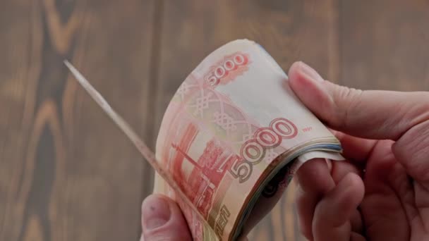 Caucasian hand checking small stack of russian ruble banknotes — Wideo stockowe