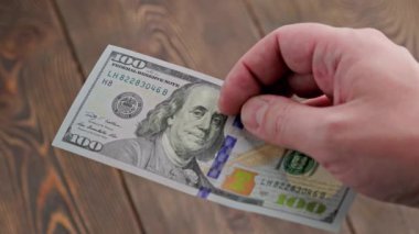 exchange one hundred us dollar banknote into two russian ruble banknotes