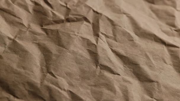 Looped spinning close-up full-frame background of crumpled brown craft paper — Video Stock