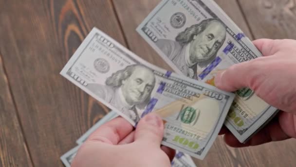 Caucasian hand counting small stack of hundred us dollar banknotes — Stockvideo