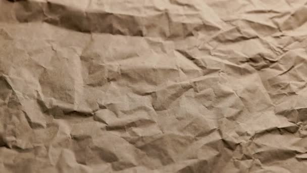 Looped spinning close-up full-frame background of crumpled brown craft paper — Stock Video