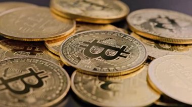 bitcoin coins on black background - closeup full-frame spinning background