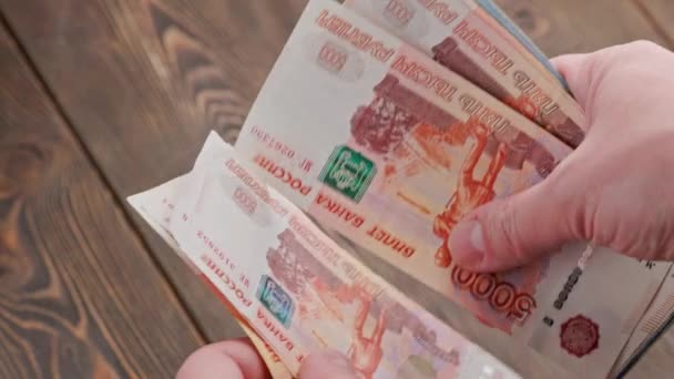 Caucasian hand counting small stack of russian ruble banknotes — Stok video