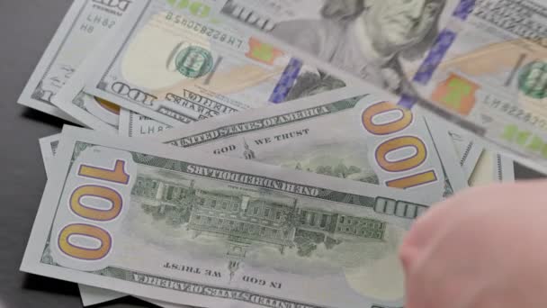 Caucasian hand counting small stack of hundred us dollar banknotes — Video
