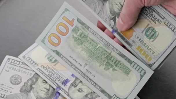 Caucasian hand counting small stack of hundred us dollar banknotes — Video