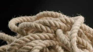 spinning looped rotating view of entangled rope on black background