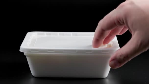 Hand opening rectangular styrofoam container with hot cooked instant noodles — Stock Video