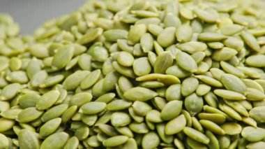 peeled pumpkin seeds full-frame spinning background