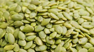 peeled pumpkin seeds full-frame spinning background