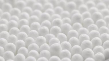 closeup spinning full-frame macro background of cotton earbud heads