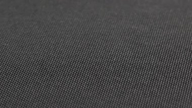 close-up spinning full-frame background of black or gray dense fabric