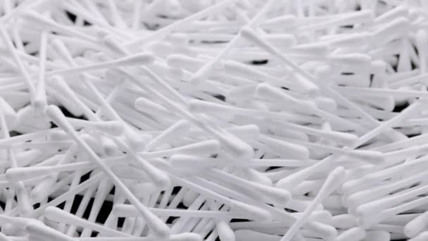 Pile of q-tips or cottom buds slowly rotating on black background — Vídeos de Stock