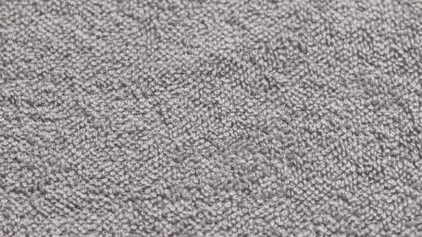 Closeup loopable background of gray soft cotton towel — Vídeos de Stock