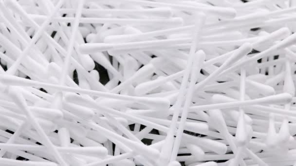 Pile of q-tips or cottom buds slowly rotating on black background — Stok video