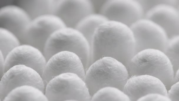 Closeup spinning full-frame macro background of cotton earbud heads — Stok video