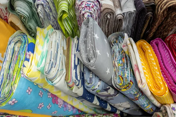 Many rolls of colored fabric with different patterns — Foto de Stock