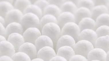 closeup spinning full-frame macro background of cotton earbud heads