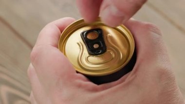Closeup of soda or beer opening by caucasian hands