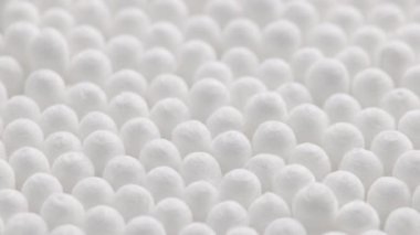 closeup spinning full-frame macro background of cotton earbud heads