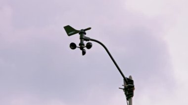 Weather vane wind gauge for direct and strength. sunset Stormy clouds in the backgeound. Rela-time. Tula, Russia - June 5, 2022.