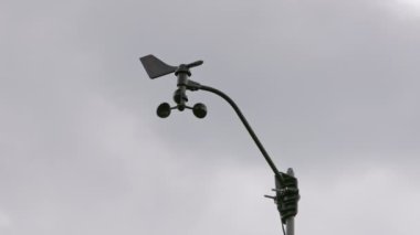 Weather vane wind gauge for direct and strength. sunset Stormy clouds in the backgeound. Rela-time.