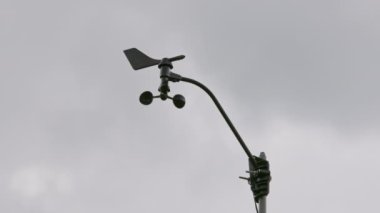 Weather vane wind gauge for direct and strength. sunset Stormy clouds in the backgeound. Rela-time.