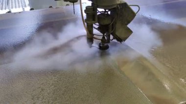 waterjet cutting process, making many tiny hioles in a thick steel sheet