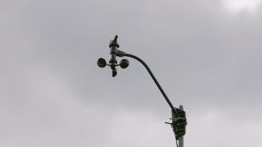 Weather vane wind gauge for direct and strength. sunset Stormy clouds in the backgeound. Rela-time.