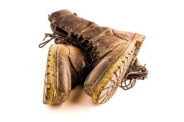 pair of dirty military style light ankle boots isolated on white background - front view